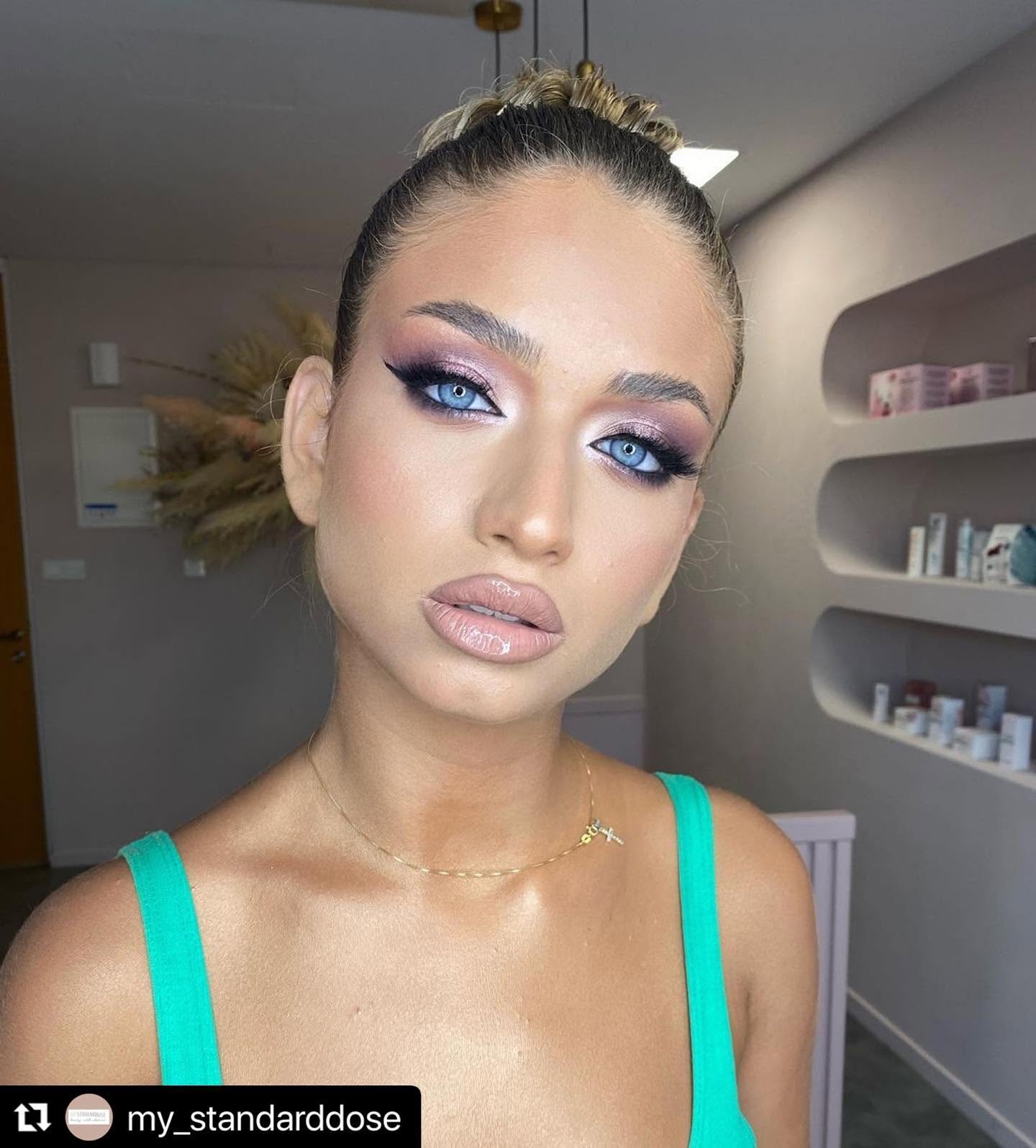 Editorial makeup with lilac shimmer eye, sculpted brows and glossy nude lip by Giannis Karaolis