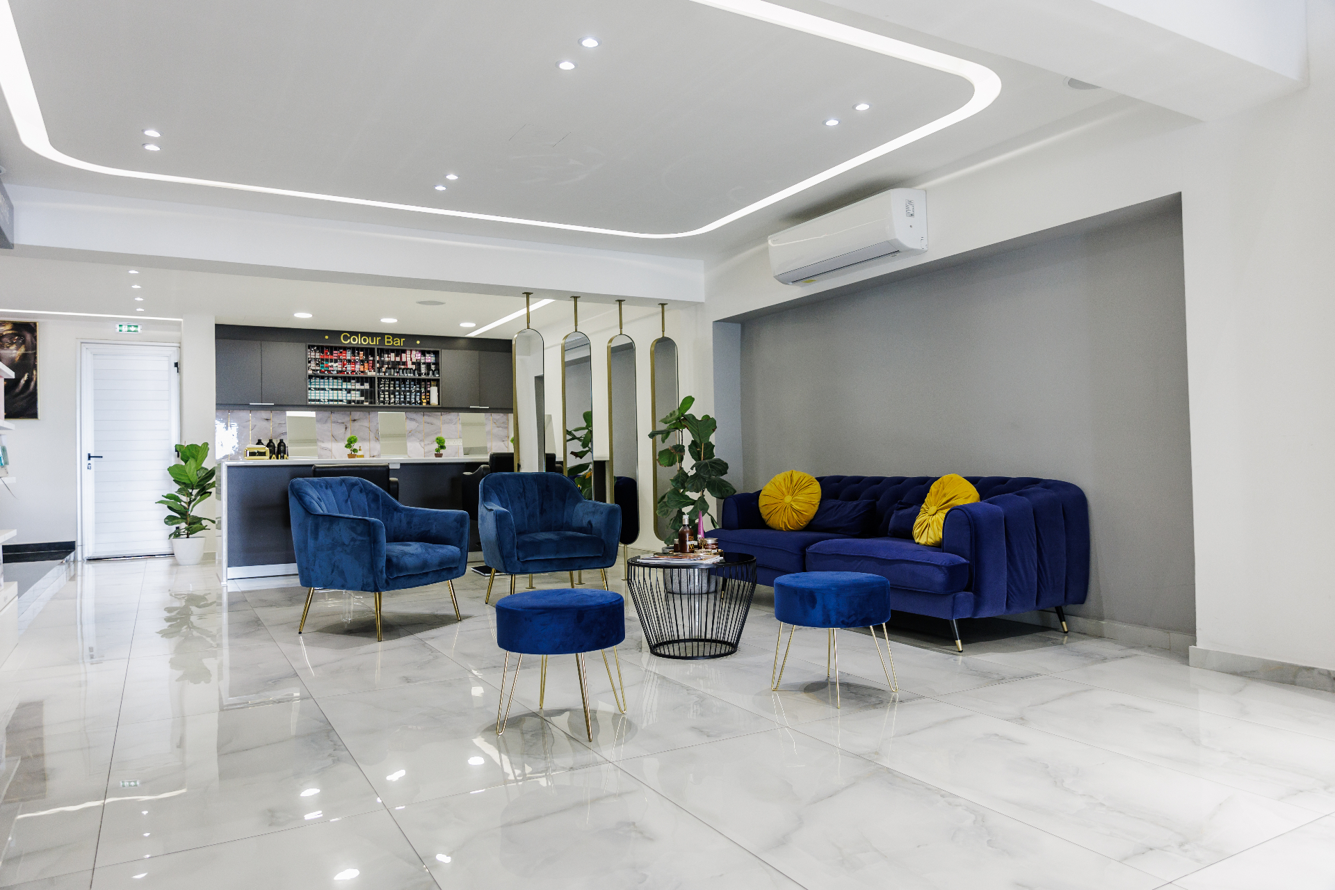 Waiting area with velvet seating beside the salon Color Bar in Paphos