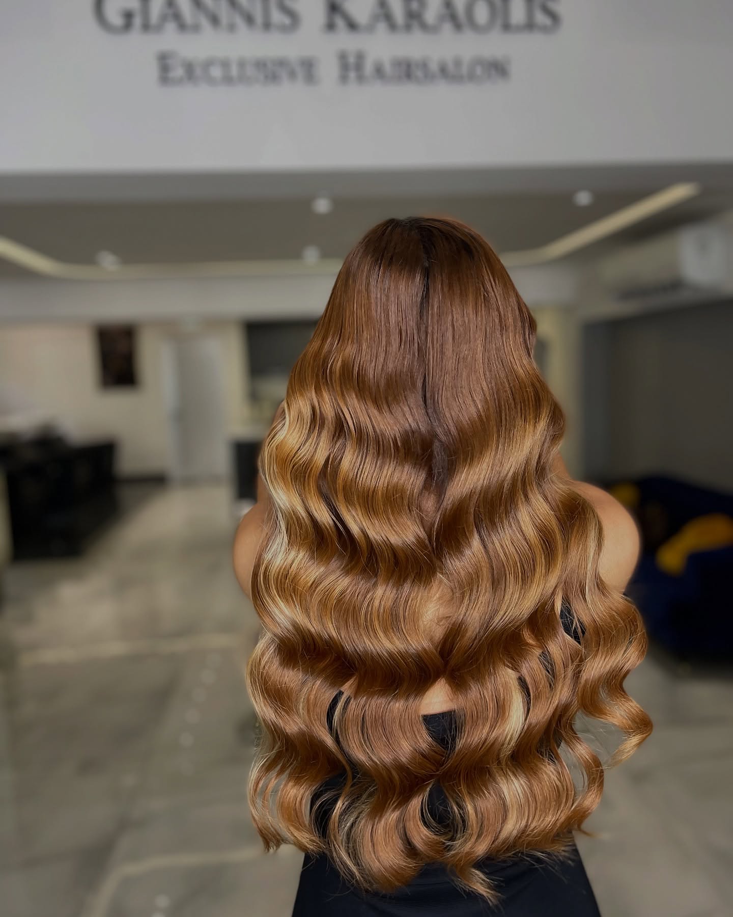 Long caramel blonde hollywood waves styled at Giannis Karaolis salon in Paphos